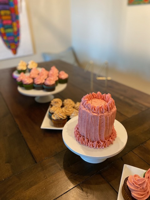 Pink celebration cake with matching cupcakes